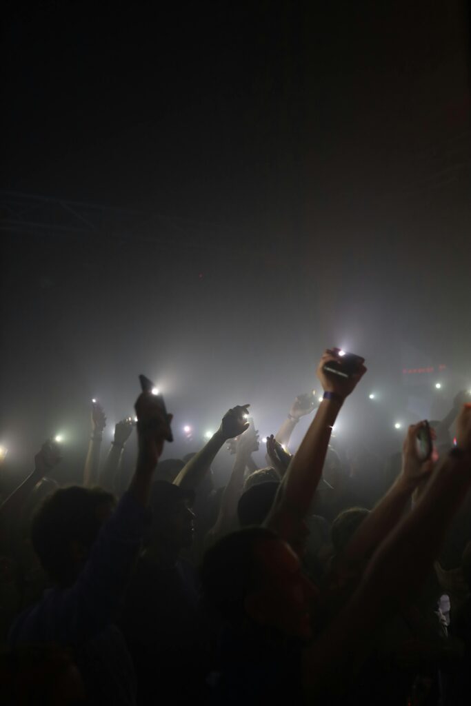 pexels-photo-28201137-28201137 Silhouettes of concert attendees raising lights during a night performance in Minsk.